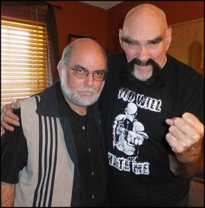 Journalist and filmmaker Mark Nowotarski (left) poses with professional wrestler Ox Baker. Nowotarski has a new documentary on wrestling, called “Battles, Bouts & Brawls,” which is showing next Thursday (May 29) at the Maple Theater.