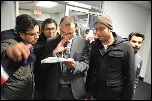 Center: A man who identified himself as an election challenger looks over the results in Hamtramck City Hall of Tuesday's Hamtramck election results. The man threatened to "file" for having his photograph taken.