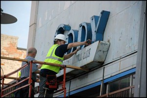The sign for the former store is taken down.