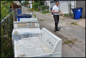 After Monday’s flooding, many households were forced to throw out contaminated and ruined appliances and other items. Some residents decided to salvage what they could and scrubbed their possessions clean.