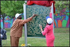 Hamtramck School Board President Titus Walters and Linda Forte of Comerica Bank unveil a historical marker for Hamtramck Stadium, home to the famed Detroit Stars of the Negro League, during a ceremony Thursday afternoon. Comerica Bank donated $5,000 for the marker.