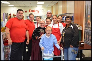 The clan at Bear’s Deli poses with Mayor Karen Majewski (center) at the deli’s recent grand opening. The eatery is at the former location of the Kowalski Deli on Jos. Campau.