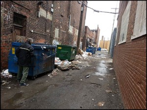 Litter can be found just about everywhere in Hamtramck, including in the alleys in the business districts where certain business owners don’t seem to mind allowing their trash to pile over dumpsters. Photo by Robert Zwolak