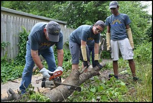 Students and adult volunteers with the GM internship program do some needed pruning and cleaning up at the Holbrook Garden.