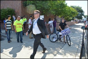 on election day, City Clerk August Gitschlag has to constantly remind campaign volunteers to stay at least 100 feet away from polling places.