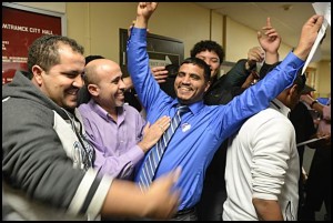 Top vote-getter Saad Almasmari(center) celebrates his victory to city council on election night.