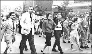 Former Mayor Robert Kozaren towers over a parade along Jos. Campau.