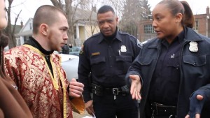 Taras Nykoriak, left, talks with Detroit police about issues happening with the St. Andrew Ukrainian Orthodox Church located just outside of Hamtramck. Nykoriak was recently imprisoned for illegally redeeming US bonds belonging to the church.