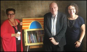 Dickinson West Elementary School teacher Suzana Bosnjakovski, Stuart Tucker and Dr. Mary-Catherine Harrison pose next to the newly installed Little Library that students will be able to access for free. Tucker, a Hamtramck resident, and Harrison helped bring about the library.