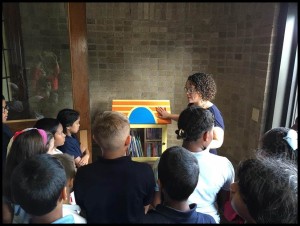 Dickinson West students are introduced to the Little Library by Dr. Mary-Catherine Harrison.