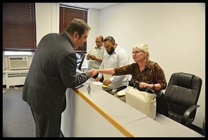 Kyle Tertzag (left) shakes hands with Mayor Karen Majewski after being appointed as interim city manager. He will start work once the contract expires for current City Manager Katrina Powell on June 30. Tertzag’s appointment followed a contentious special meeting the city council held on Wednesday.