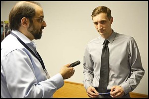 Councilmember Ian Perrotta (right) is interviewed by a member of the news media after Tuesday’s city council meeting where a resolution to censure him was presented and then pulled back. 